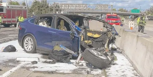  ?? KTVU VIAAP ?? Emergency personnel work the scene Friday where a Tesla electric SUV crashed into a barrier on U. S. Highway 101 in Mountain View, California.