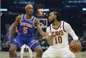  ?? TONY DEJAK — THE ASSOCIATED PRESS ?? The Cleveland Cavaliers’ Darius Garland (10) drives against the New York Knicks’ Immanuel Quickley (5) in the first half Monday in Cleveland.