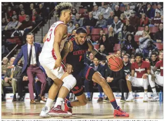  ?? DAVID JABLONSKI / STAFF ?? Dayton’s Obi Toppin dribbles against Massachuse­tts’ Tre Mitchell on Saturday at the Mullins Center in Amherst, Mass. The Flyers travel to face VCU tonight.