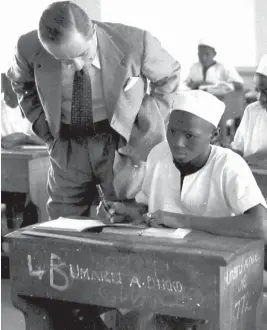  ?? PHOTOS: BABA SHETTIMA ?? Governor General Sir John Macpherson admiring the work of Umaru Dikko, during a visit to Barewa College Zaria in 1952.