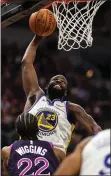  ?? BRACE HEMMELGARN — USA TODAY SPORTS ?? The Warriors’ Draymond Green dunks during the second quarter of Tuesday’s victory over Minnesota.