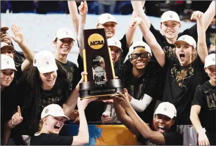  ?? (AP) ?? Stanford players celebrate with the trophy after the championsh­ip game against Arizona in the women’s Final Four NCAA college basketball tournament at the Alamodome in San Antonio. Stanford won 54-53.