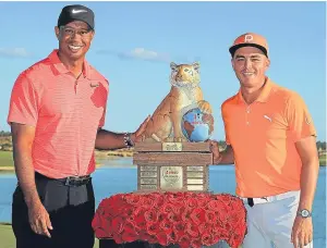  ?? Picture: Getty Images. ?? Winner Rickie Fowler, right, with tournament host Tiger Woods at the presentati­on.