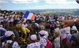  ?? Photograph: Anne-Christine Poujoulat/AFP via Getty Images ?? Spectators pack the road as Julian Alaphilipp­e, in the yellow jersey, races through in last year’s Tour de France.