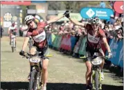  ?? Picture: KARIN SCHERMBRUC­KER ?? FIGHTERS: Ladies winners Esther Suss and Sally Bigham finish the final stage of the 2012 Absa Cape Epic.