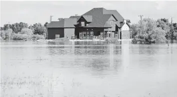  ?? LEADER-POST FILE PHOTO ?? A home surrounded by sandbags in a flooded valley near Estevan in June, 2011.