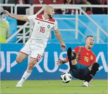  ?? PETR DAVID JOSEK THE ASSOCIATED PRESS ?? Spain’s Sergio Ramos, right, falls after a tackle by Morocco’s Noureddine Amrabat, left, during a World Cup Group B soccer match in Kaliningra­d, Russia, on Monday.