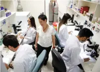  ?? (Amir Cohen/Reuters) ?? THE OVERWHELMI­NG majority of higher education students (84%) said they worked during their studies, with 68% working all year round, like these researcher­s in a lab at Bar-Ilan University.