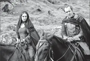  ?? By Helen Sloan, HBO ?? New Game player: New character Melisandre (Carice van Houten) rides with Stannis Baratheon (Stephen Dillane). Melisandre, a red priestess, advises Baratheon as he seeks the Iron Throne.