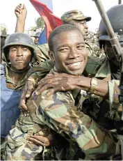  ?? /Reuters/File ?? Flashback: Haitia’s then armed forces commander-in-chief Guy Philippe celebrates with soldiers in Cap-Haitien, Haiti after the coup in 2004
