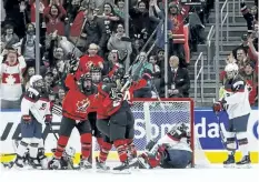  ?? JASON FRANSON/THE CANADIAN PRESS ?? Team Canada celebrates the game winning goal against Team USA during the final game of their pre-Olympic series against the U.S.