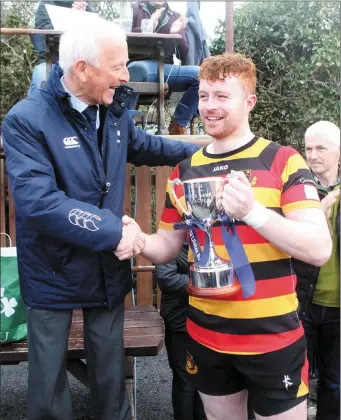  ??  ?? IRFU delegate Michael Cunningham presents Sligo RFC captain Shane Boyle with the Ulster Bank League 2C trophy.