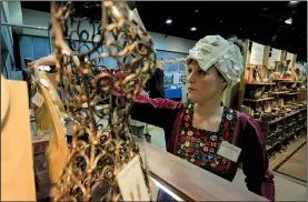  ?? Democrat-Gazette file photo ?? The Arkansas Craft Guild Christmas Showcase, from Friday through Dec. 6 at the Statehouse Convention Center in Little Rock, comes with a bagful of jewelry, pottery and other creative wares by more than 100 artists — as in this scene from last year’s...