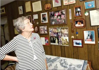  ?? MATT JOHNSON/CONTRIBUTI­NG PHOTOGRAPH­ER ?? Irene Wilkes Gray admires a wall of momentos in the den of her home in Searcy. The 79-year-old has traveled to 103 countries, and her home is filled with treasures from her travels.