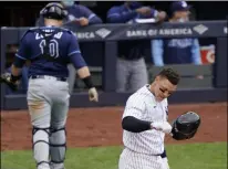  ?? KATHY WILLENS - THE ASSOCIATED PRESS ?? New York Yankees Aaron Judge tosses his batting helmet after striking out stranding two runners on base during the fifth inning of a baseball game against the Tampa Bay Rays, Sunday, April 18, 2021, at Yankee Stadium in New York. Rays catcher Mike Zunino (10) heads to the dugout.