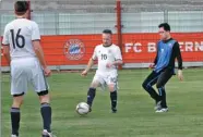  ?? PROVIDED TO CHINA DAILY ?? Rolf Reinhard (center), mayor of Abtsteinac­h in Germany and a member of the German National Soccer Team of Mayors, plays in a soccer match at the Sino-German Ecopark in Qingdao, Shandong province, on Wednesday.