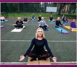  ??  ?? Calm: Showing her class the seated meditation pose