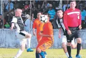  ??  ?? DUELO. El portero de Oro Verde despeja el balón. Un jugador del Juventus (blanco) trata de quitarse un rival.