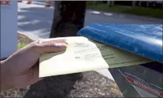  ?? David SANTIAGO / MIAMI HERALD VIA Ap ?? miami-dade resident James Curity deposit a ballot in a mailbox outside City Hall during early voting for the general election in miami Beach, Fla., last October.