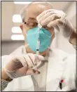  ??  ?? CVS Pharmacist Gerard Diebner prepares the COVID-19 vaccine for the nursing home residents at Harlem Center for Nursing and Rehabilita­tion, a nursing home facility, on Jan 15, in Harlem neighborho­od of New York. (AP)