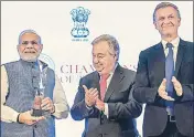  ?? PTI ?? Prime Minister Narendra Modi receives the Champions of The Earth award as UN secretary general Antonio Guterres and environmen­t programme director Erik Solheim congratula­te him in New Delhi on Wednesday.