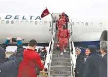  ?? KENT GIDLEY/ALABAMA PHOTO ?? Alabama football players exit the plane Wednesday after arriving in New Orleans for Monday night’s Sugar Bowl against Clemson.