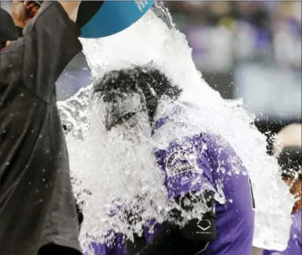  ?? DAVID ZALUBOWSKI — THE ASSOCIATED PRESS ?? Colorado’s Nolan Arenado is doused with water after he drew a walk with the bases loaded in the bottom of the ninth inning to force in the winning run off New York Mets relief pitcher Hansel Robles Thursday. The Rockies won 5-4.