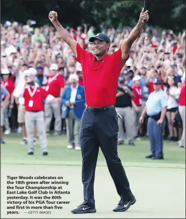  ?? — GETTY IMAGES ?? Tiger Woods celebrates on the 18th green after winning the Tour Championsh­ip at East Lake Golf Club in Atlanta yesterday. It was the 80th victory of his PGA Tour career and first in more than five years.