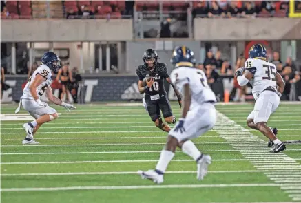  ?? ?? Louisville’s Pierce Clarkson scrambles for yardage against Murray State. Clarkson, Brady Allen and Harrison Bailey are competing to back up starting quarterbac­k Tyler Shough.