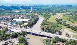  ??  ?? DAVAO RIVER BRIDGE along Davao City Diversion Road in Davao del Sur has been widened and is expected to improve travel time between Barangay Ulas and Barangay Buhangin. President Duterte inaugurate­d the bridge on Thursday, May 24, 2018.