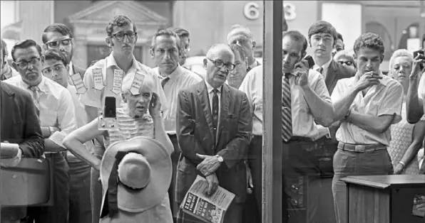  ?? Neal Boenzi/ The New York Times ?? Part of a crowd of hundreds of people gather at the Zenith television showroom at Fifth Avenue and 54th Street in New York to watch as Apollo 11 begins its journey to the moon on July 16, 1969.