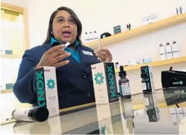  ?? JOE CAVARETTA/STAFF PHOTOGRAPH­ER ?? Paula Harrilal, executive vice president of Knox Medical, shows the clinic’s products during the marijuana dispensary opening Tuesday in Lake Worth.