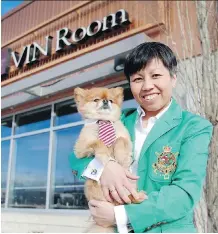  ?? RYAN MCLEOD ?? Vin Room owner Phoebe Fung cuddles her pet pooch, Dom, after Alberta Health Services dubbed her restaurant pet-friendly.