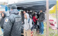  ?? GILBERT NGABO TORONTO STAR ?? Residents stood in long lines for hours in the rain as they tried to get access to their apartments in the fire-damaged building.