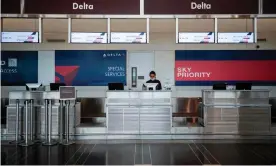  ?? Photograph: Andrew Caballero-Reynolds/AFP/Getty Images ?? A Delta employee waits for passengers at Ronald Reagan Washington national airport. Twenty per cent of the company’s workforce is taking voluntary retirement­s.