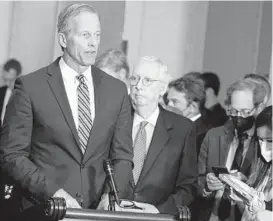  ?? MARIAM ZUHAIB/AP ?? Senate Minority Leader Mitch McConnell of Ky., second from left, listens as Sen. John Thune, R-S.D., speaks during a news conference on April 26 in Washington.