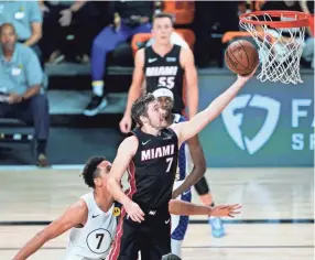  ?? ASHLEY LANDIS/POOL PHOTO VIA AP ?? Heat guard Goran Dragic, right, scores past Pacers guard Malcolm Brogdon, left, during the first half Saturday.