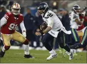  ?? NHAT V. MEYER — BAY AREA NEWS GROUP ?? Seattle Seahawks quarterbac­k Russell Wilson scrambles against the San Francisco 49ers’ Arik Armstead during a 2018 game in Santa Clara.