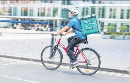  ?? 123RF STOCK PHOTO ?? A young man delivers a food order as part of the gig economy.