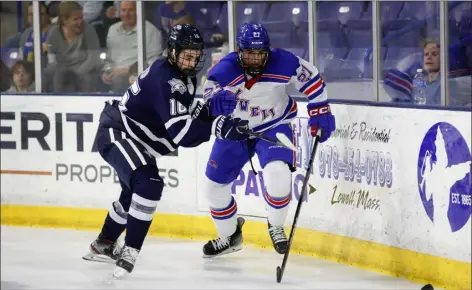  ?? PHOTO BY RICH GAGNON — UML ATHLETICS ?? Umass Lowell’s Stefan Owens, right, gets a step on a New Hampshire player in a race for a loose puck Friday at the Tsongas Center. UNH collected a 4-0win and hosted the River Hawks in a rematch Saturday night in Durham, N.H.
