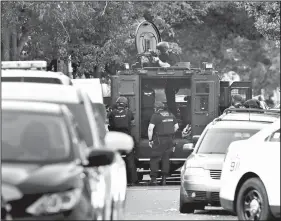  ?? AP/MATT ROURKE ?? A massive police presence is set up outside a house as officers respond to a shooting situation in the Nicetown neighborho­od of Philadelph­ia.