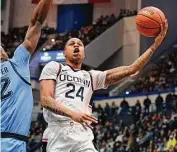  ?? Jessica Hill/Associated Press ?? UConn’s Jordan Hawkins takes a shot against Marquette on Tuesday night.