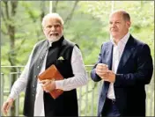  ?? PTI ?? German Chancellor Olaf Scholz, right, walks with India’s Prime Minister Narendra Modi prior to a meeting on the sidelines of the G7 summit at Castle Elmau in Kruen on Monday