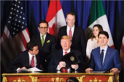  ?? CP PHOTO SEAN KILPATRICK ?? Prime Minister Justin Trudeau, Foreign Affairs Minister Chrystia Freeland, U.S. Trade Representa­tive Robert Lighthizer, U.S. President Donald Trump, Mexico’s Secretary of Economy Ildefonso Guajardo Villarreal, and President of Mexico Enrique Pena Nieto participat­e in a signing ceremony Friday in Buenos-Aires for the new United States-Mexico-Canada Agreement.