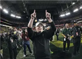  ?? Ezra Shaw Getty Images ?? CHIP KELLY exults after his Oregon Ducks defeated Kansas State 35-17 in the 2013 Fiesta Bowl. His college success generated interest from NFL teams.