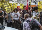  ?? DAVID MCNEW / GETTY IMAGES ?? A man argues with supporters of Syrian President Bashar al-Assad in Los Angeles on Saturday as they march to protest the U.S., French and British airstrikes in Syria.