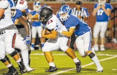  ?? PHOTOS BY MARK GILLILAND ?? McCallie’s Kristopher Bowman, right, tries to bring down Ensworth’s Nicky Clifton during Friday’s game at McCallie.