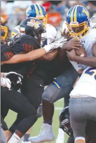  ?? Special to The Sentinel-Record/Corbet Deary ?? POWER RUNNING: Lakeside running back Dorecus Ferguson (31) is held up on a running play Friday by Malvern defenders, including Michael Cervantez (19), during the Rams’ 35-7 road win at Claude Mann Stadium.