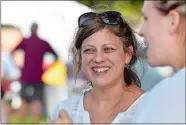  ?? TIM MARTIN/THE DAY ?? Melissa Blondin, community outreach coordinato­r for the Center for Compassion­ate Recovery and owner of Blue Ocean Art Gallery, assists patrons Saturday during the Meet the Artists &amp; Artisans event at Olde Mistick Village.