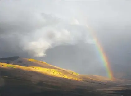 ?? Dean Krakel, Special to The Denver Post ?? A rainbow breaks through storm clouds on the hills south of Crested Butte.